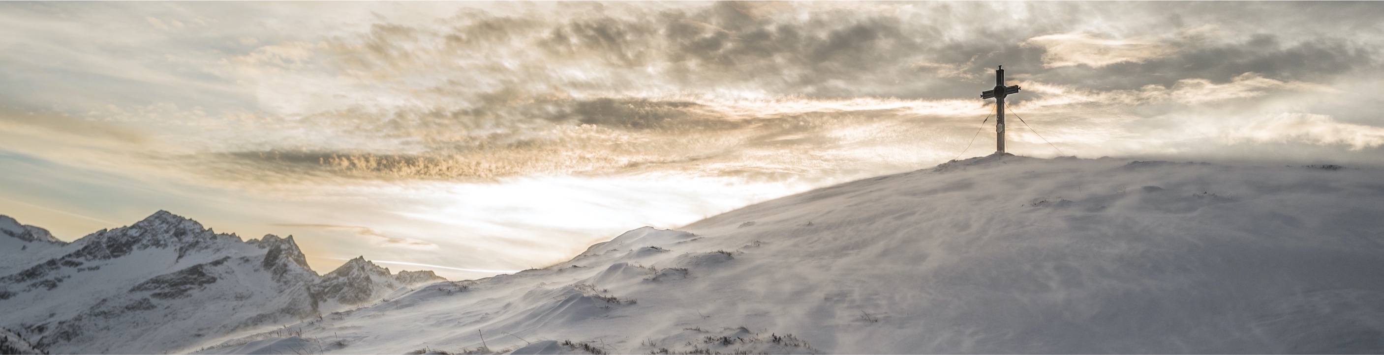 image of a cross on a snowy mountain